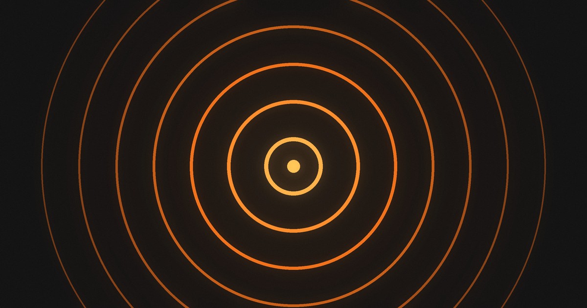 Concentric rings of warm light spreading out from a single bright point